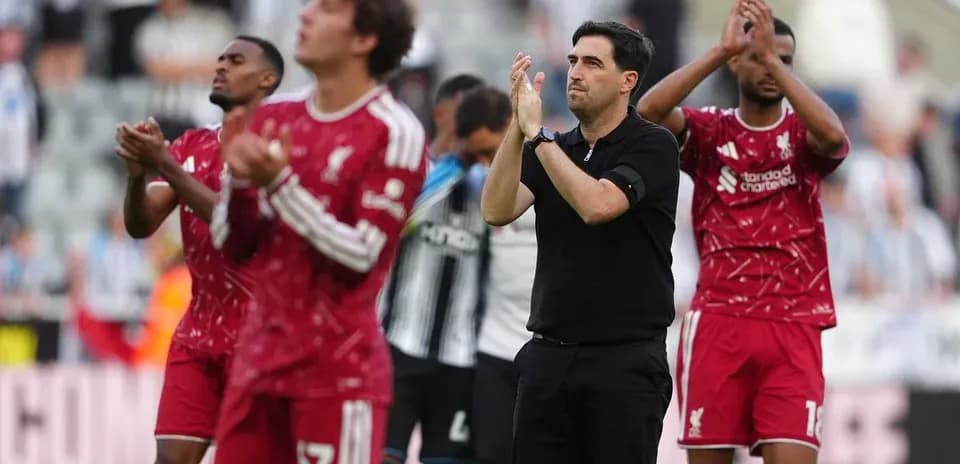 Liverpool players and manager applauding fans after match