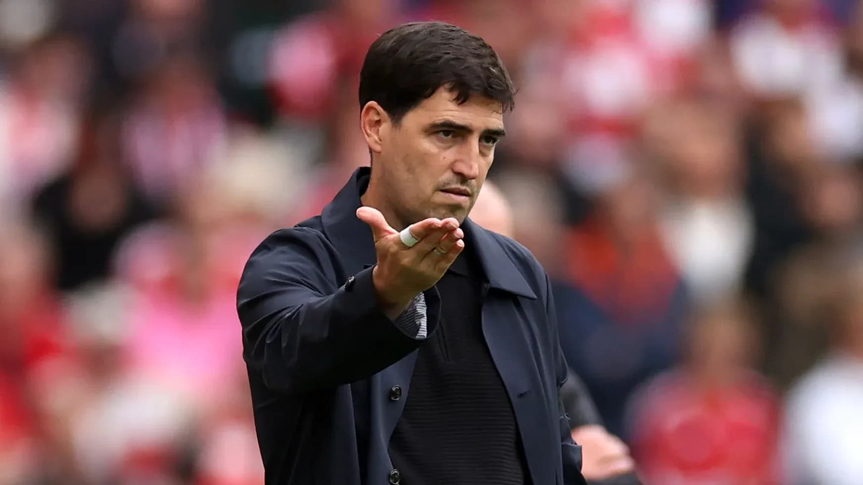 Coach gesturing during a football match