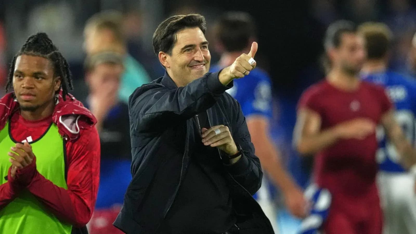 Coach celebrating with thumbs up after match