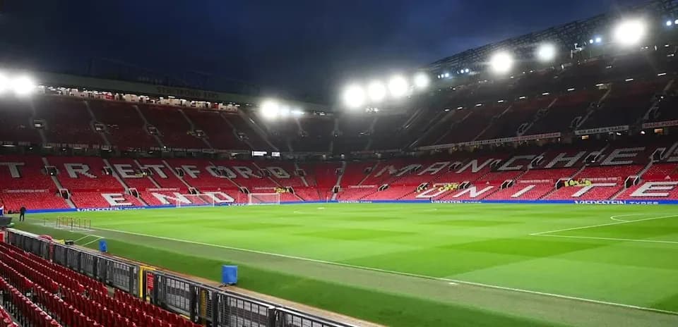 Empty Old Trafford stadium with illuminated stands