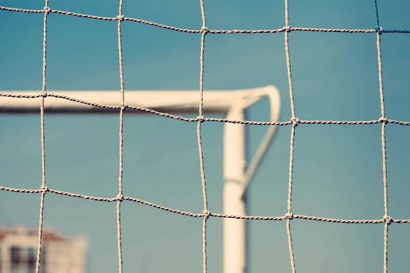 Close-up of a soccer goal net against sky