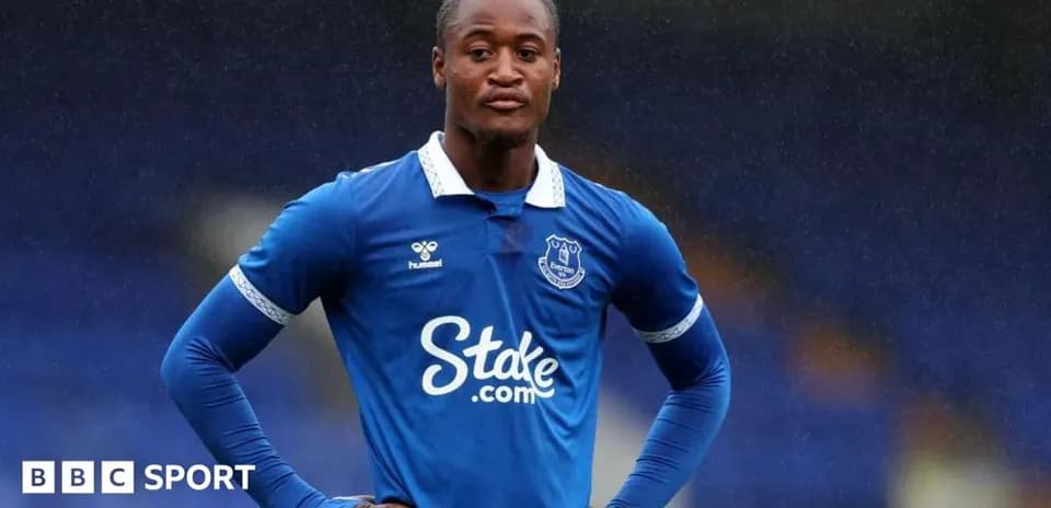 Everton player standing on pitch in blue kit