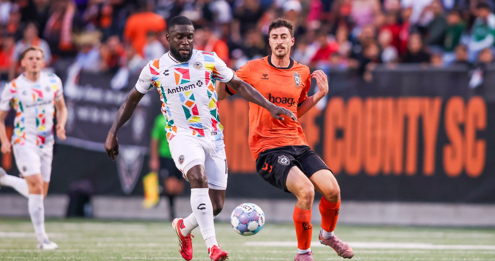 Oakland Roots player dribbling against Colorado Springs