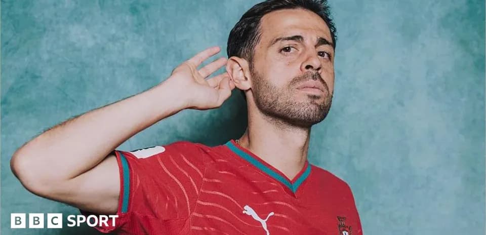 Player in red jersey posing with hand to ear