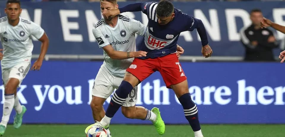 New England II player tackling Chicago Fire II opponent