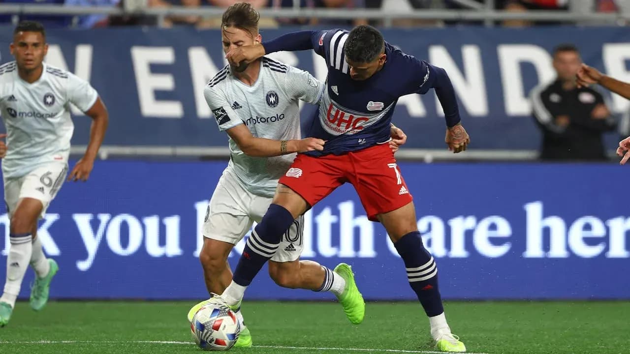 New England II player tackling Chicago Fire II opponent