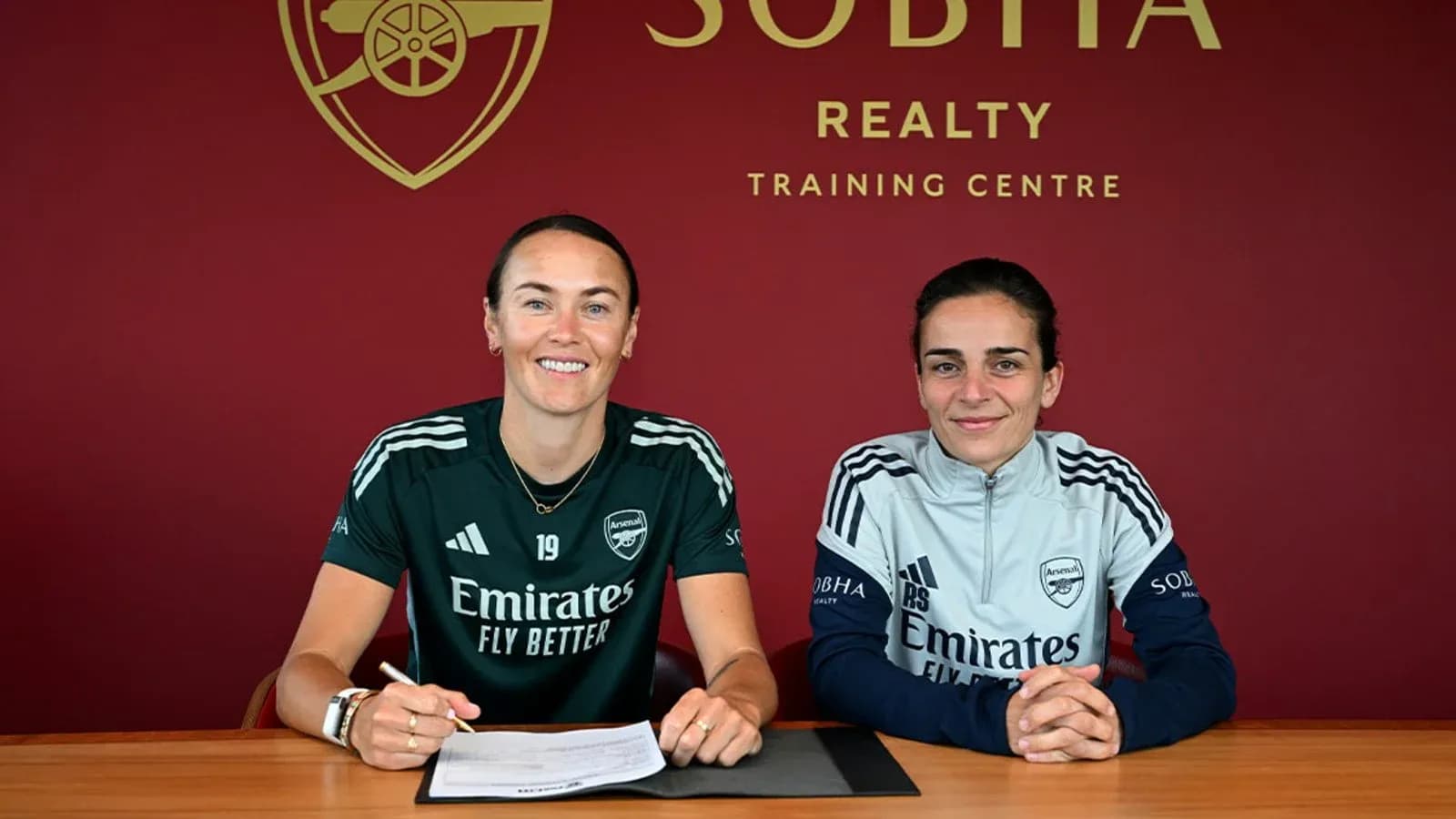 Players signing contracts at Arsenal training center