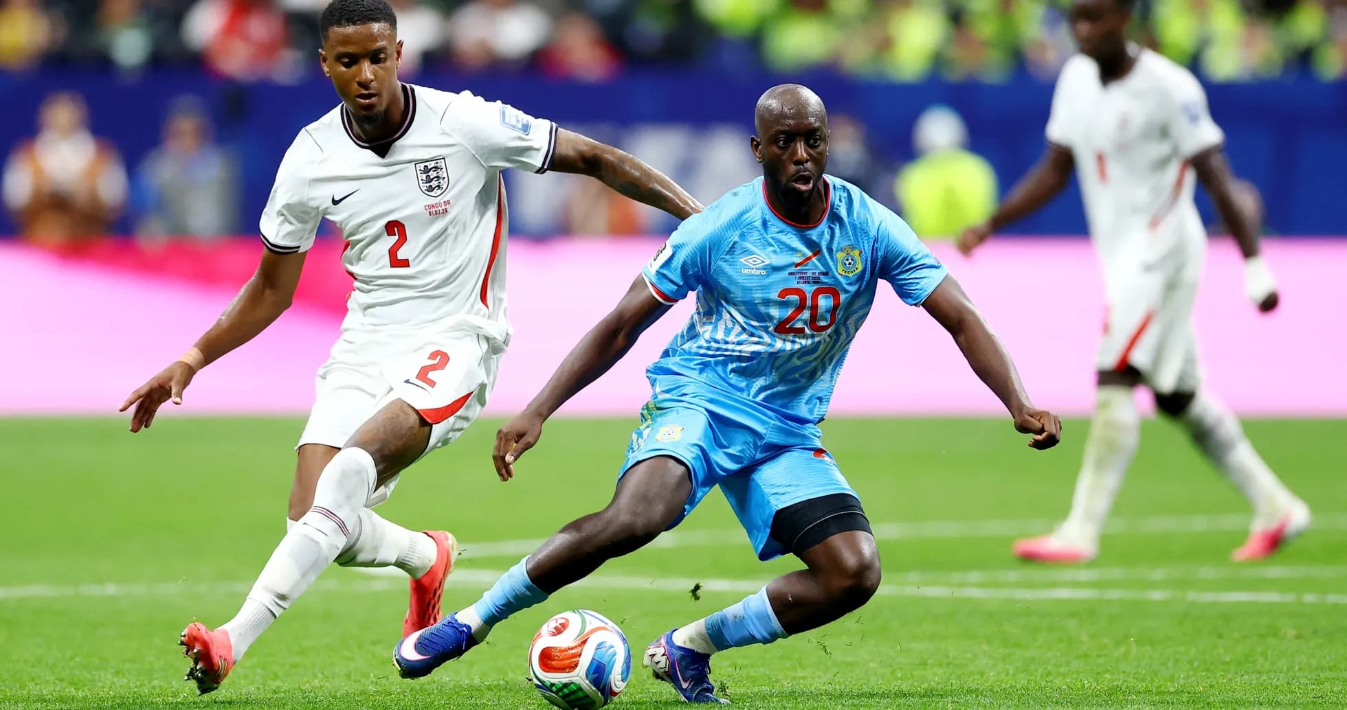 England player challenges Congo DR player for ball