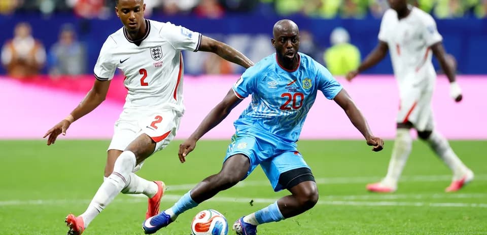 England player challenges Congo DR player for ball
