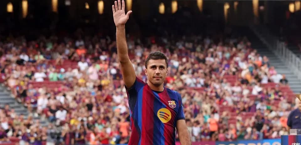 Player waving to fans at stadium presentation event