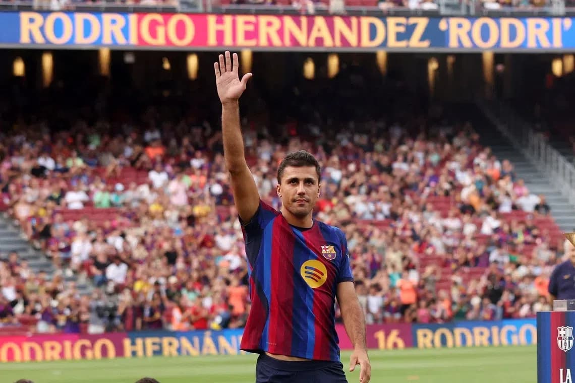 Player waving to fans at stadium presentation event
