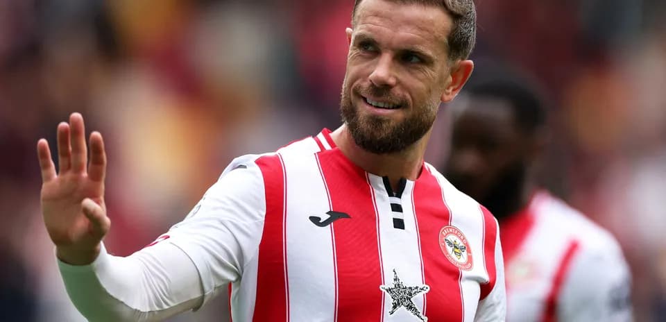 Player waving during match in Brentford kit