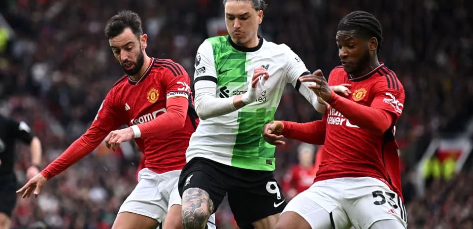Bruno Fernandes and player challenging Liverpool's striker