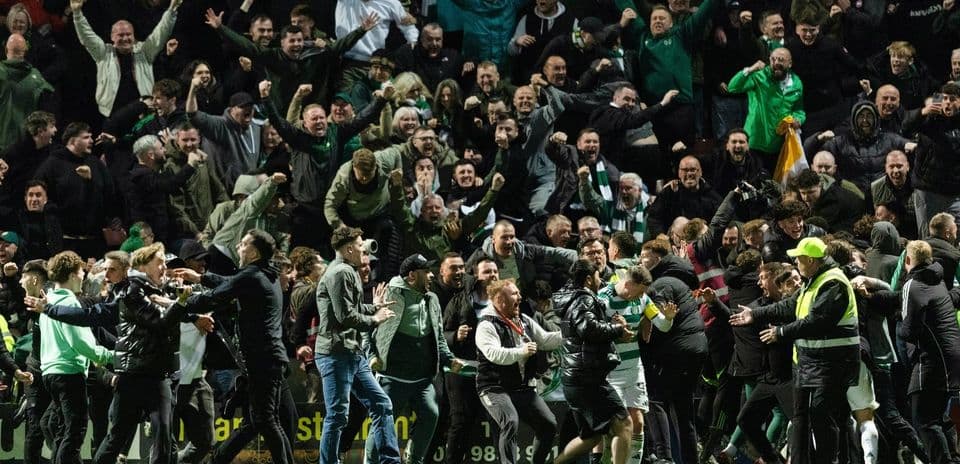 Crowd celebrating passionately at a football match
