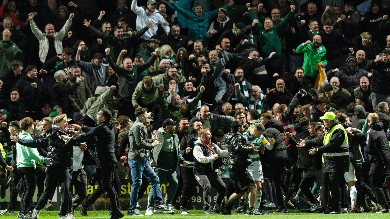 Crowd celebrating passionately at a football match