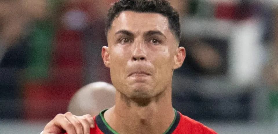 Player wearing red jersey during match celebration