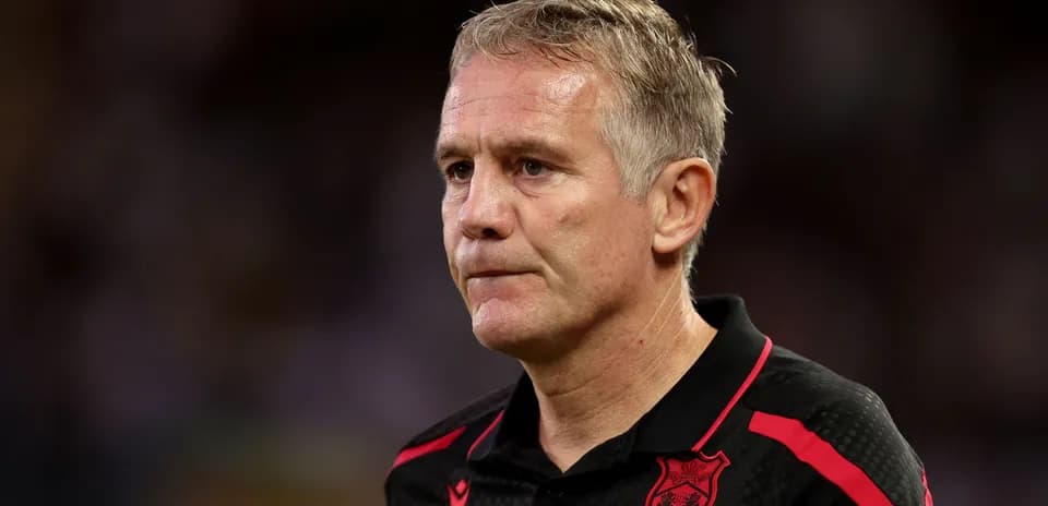 Coach in team attire during a match