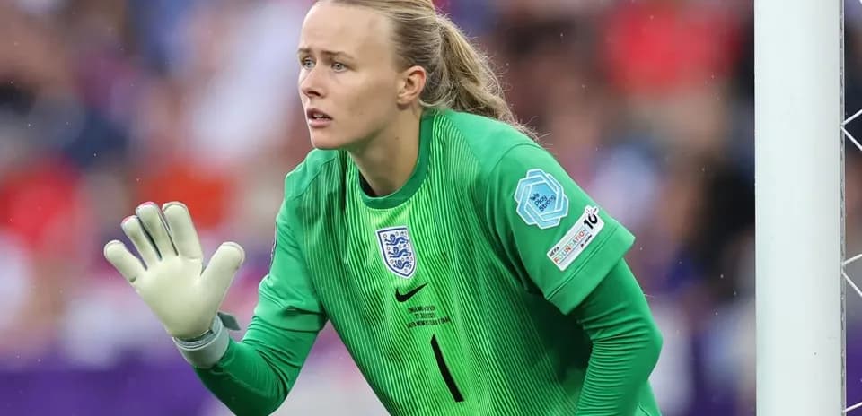 Goalkeeper in green kit preparing for play