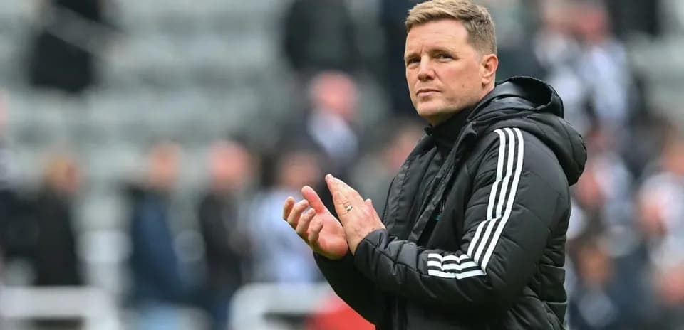 Manager applauding fans in stadium stands