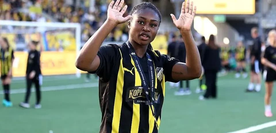 Player celebrating with raised hands on field