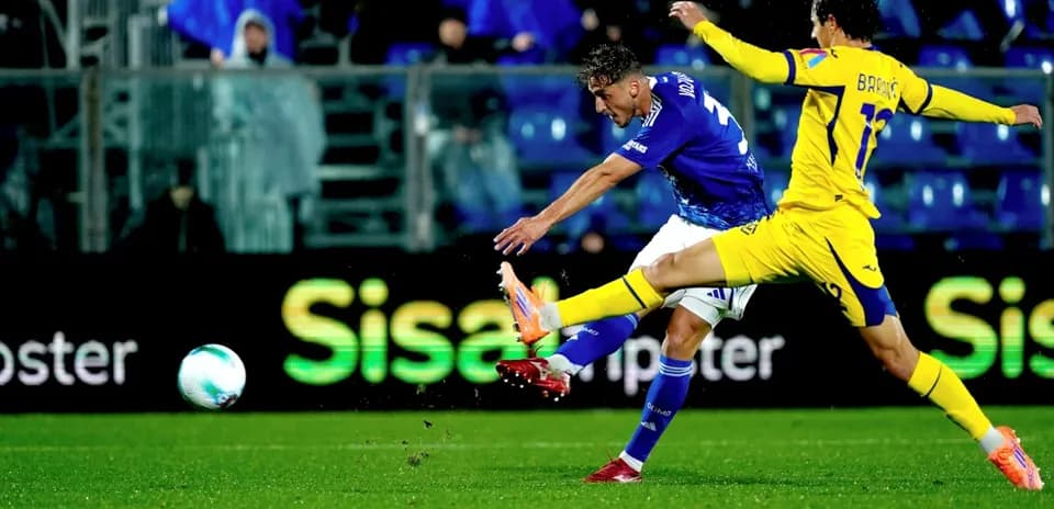 Hellas Verona player shoots on goal against Como