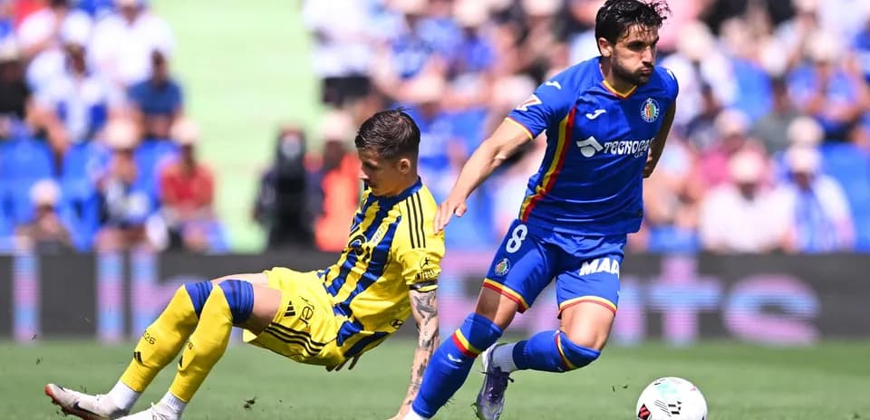 Getafe player dribbling past Oviedo opponent