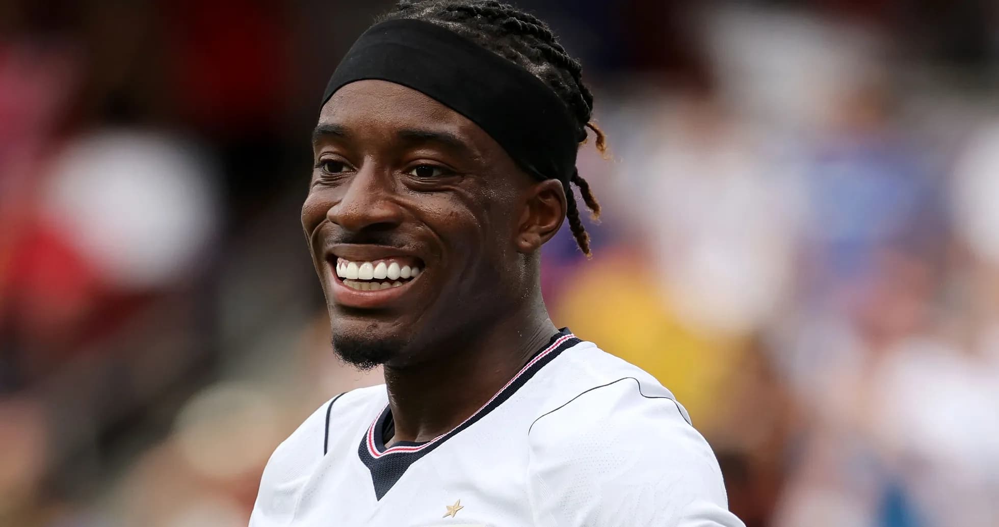 Player smiling in team jersey during match