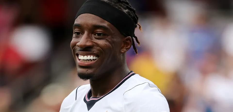 Player smiling in team jersey during match