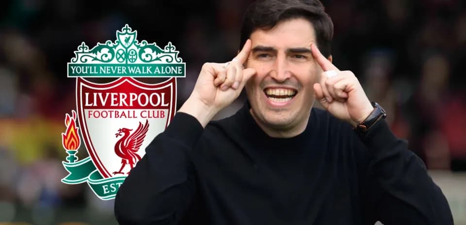 Coach celebrating with Liverpool FC logo in background