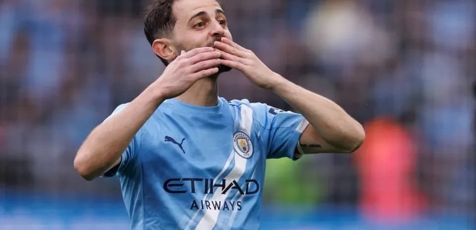 Player celebrating with hands to face on pitch