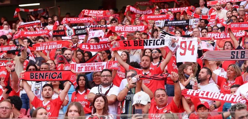 Benfica fans holding scarves in stadium