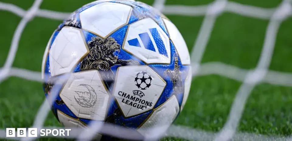 Champions League football resting in goal net