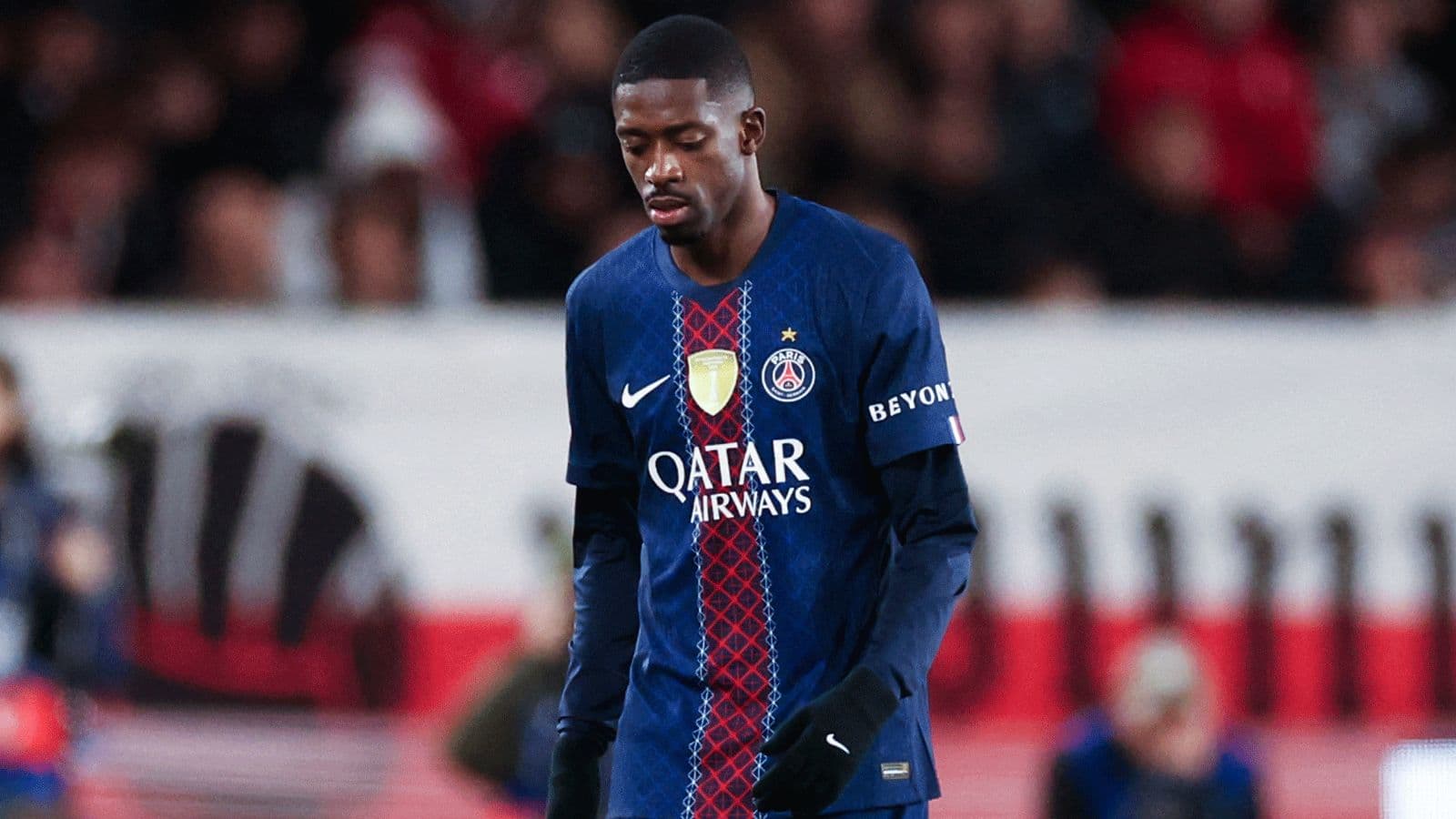 Player walking with head down in PSG jersey