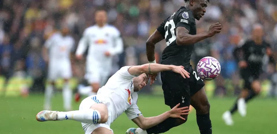 Player tackling opponent during competitive football match