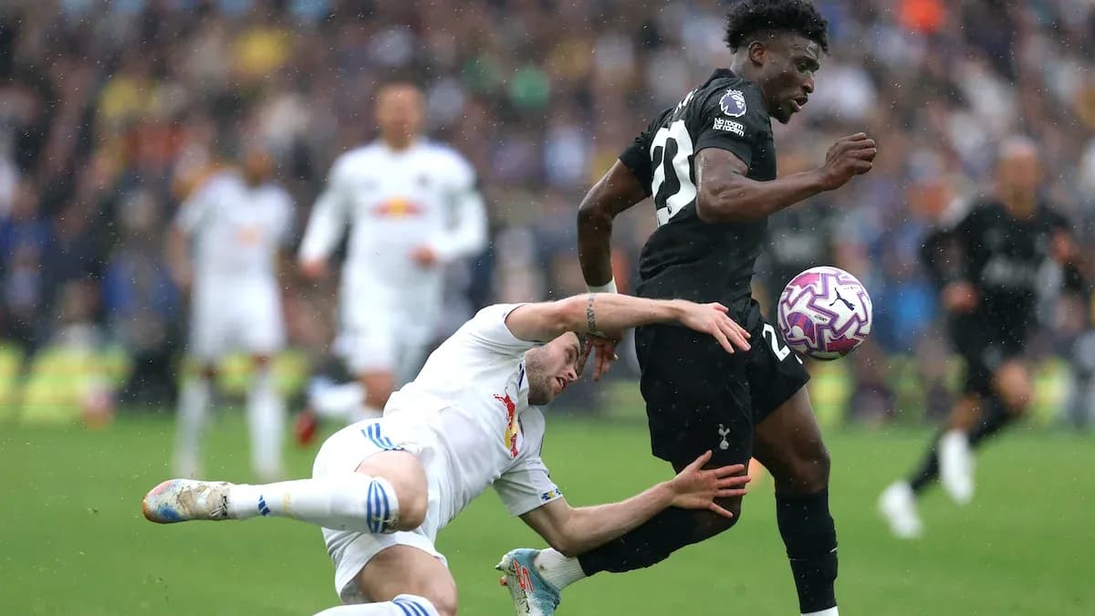 Player tackling opponent during competitive football match