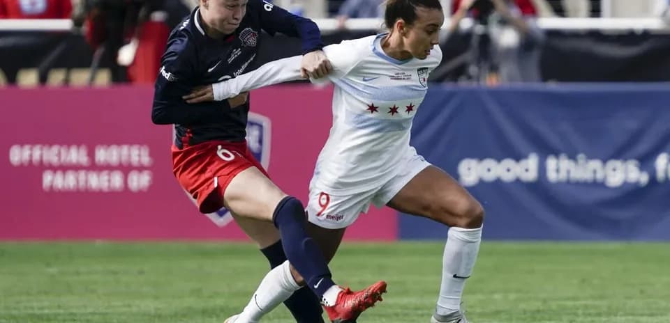 Players contesting the ball during NWSL match