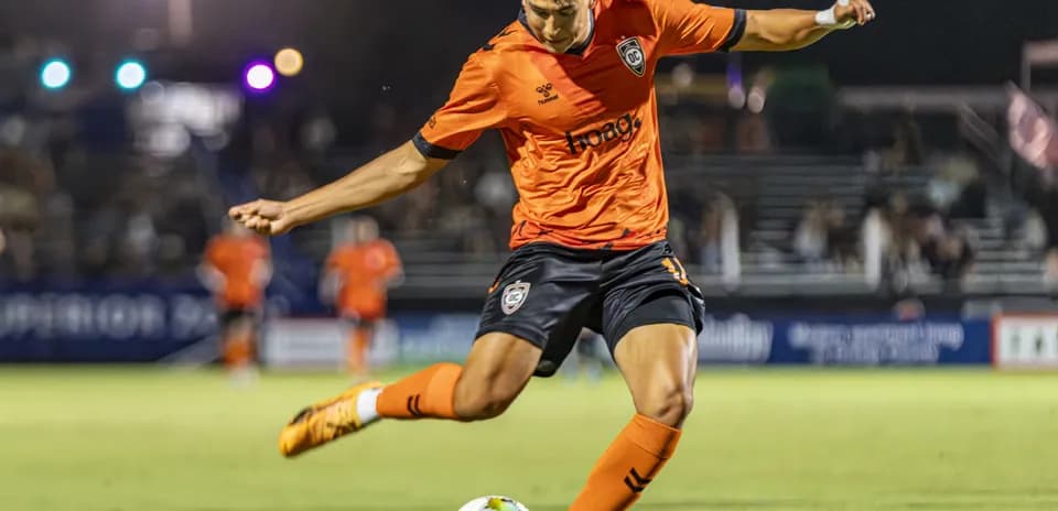 Player from Orange County SC taking a free kick