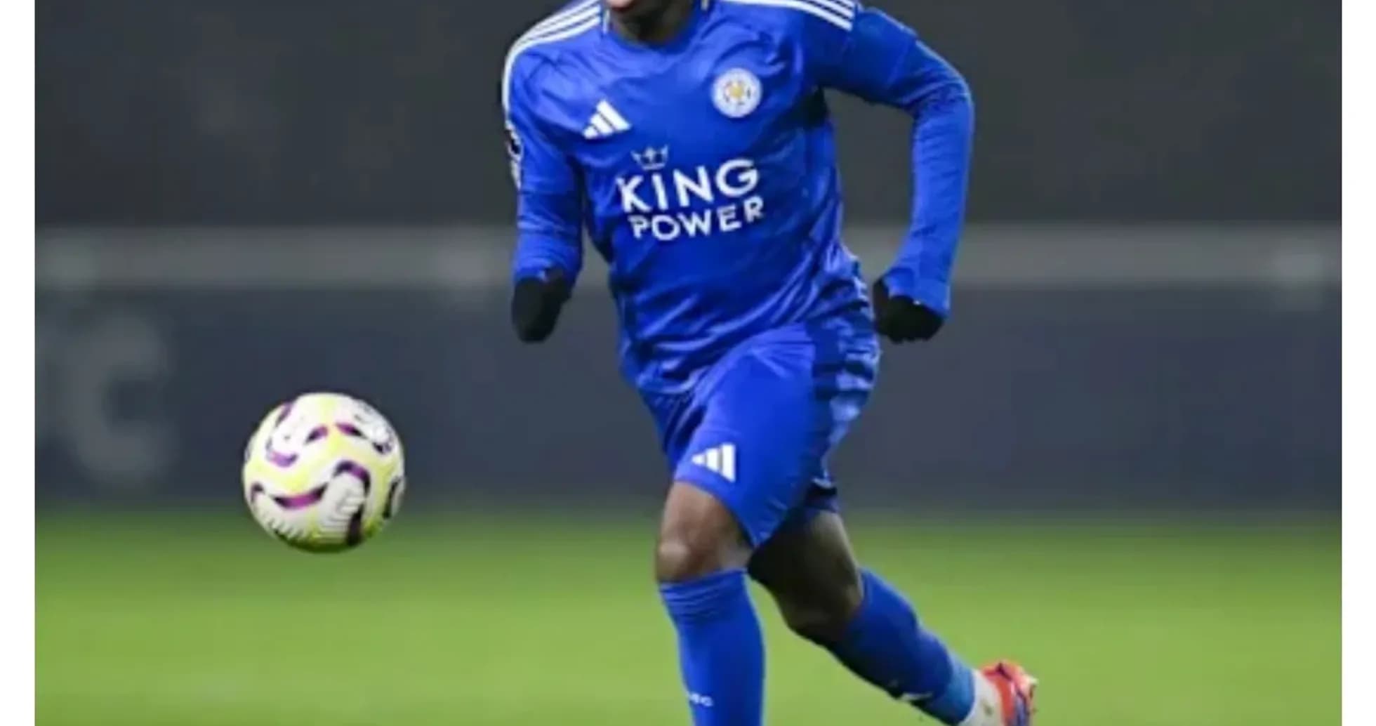 Player in blue kit running with soccer ball