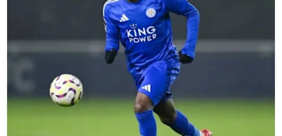Player in blue kit running with soccer ball