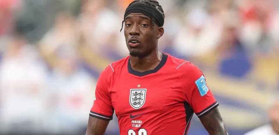 Player in red England jersey during match action