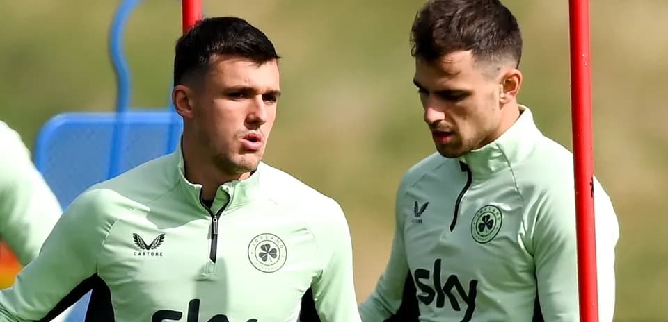Two players in training discussing on the pitch