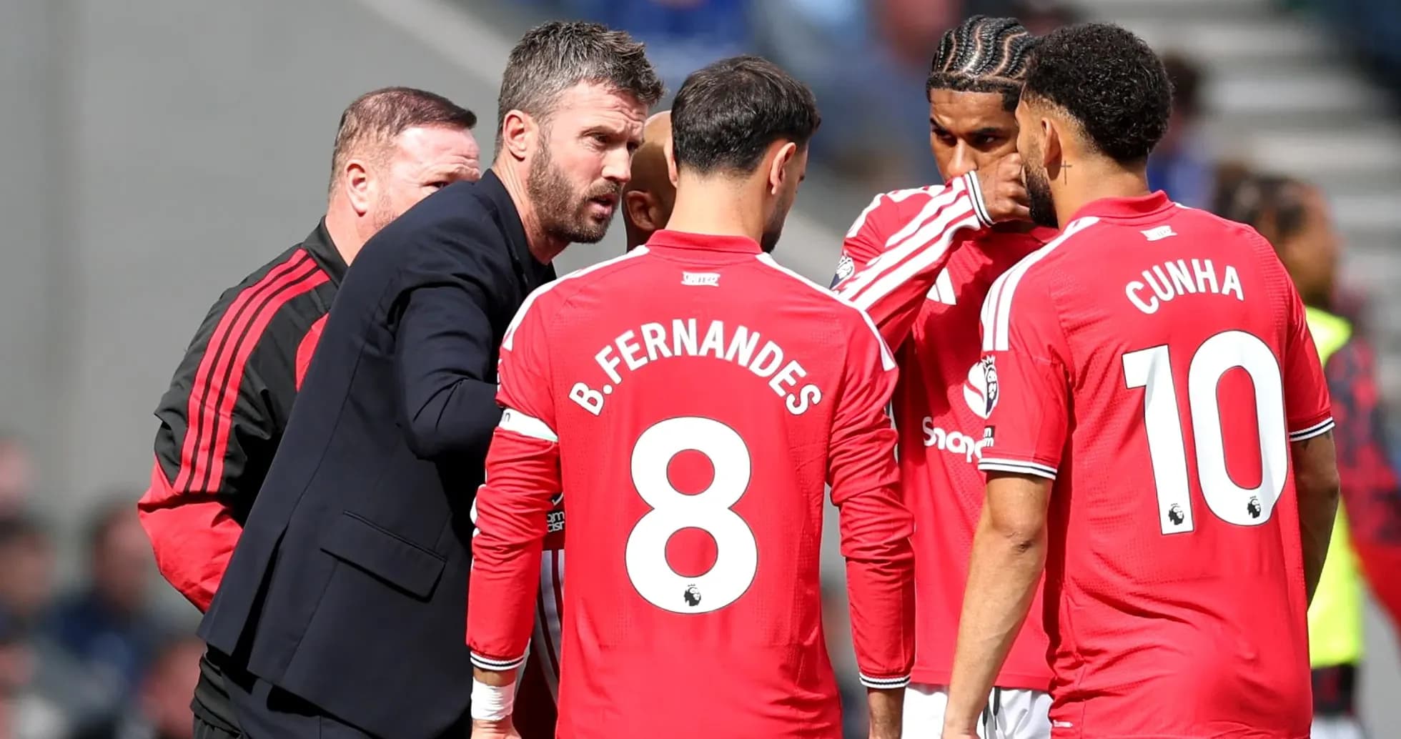 Manager discussing strategy with players during match