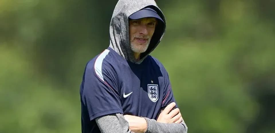 Coach observing training session in hooded sweatshirt
