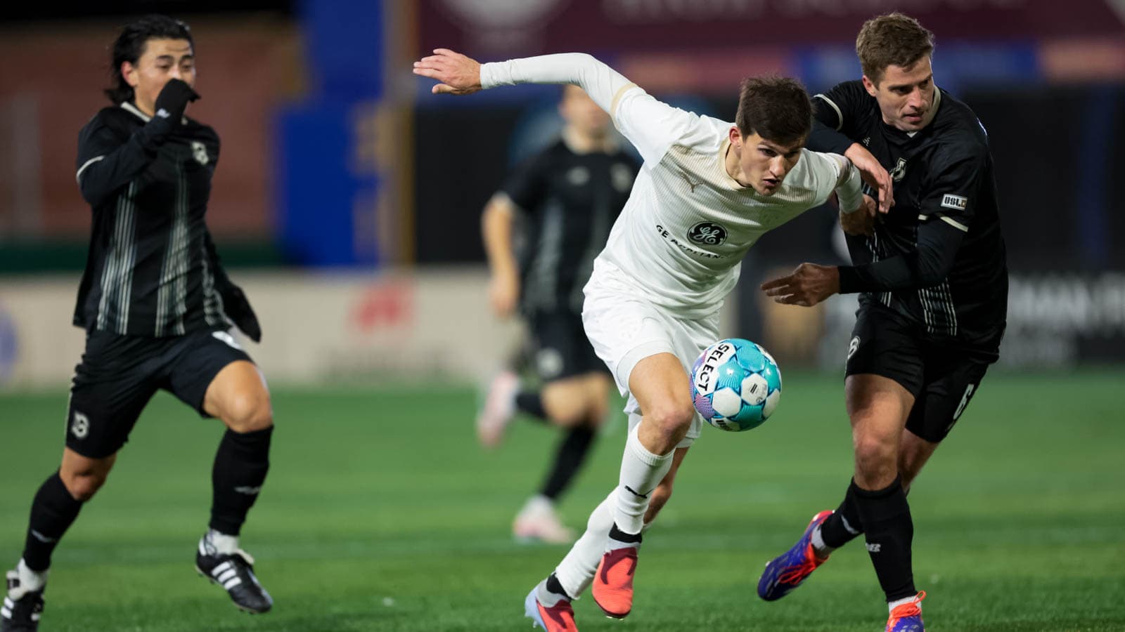 Two players competing for the ball in football match