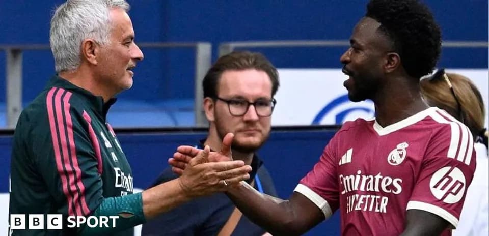 Manager and player shaking hands on pitch