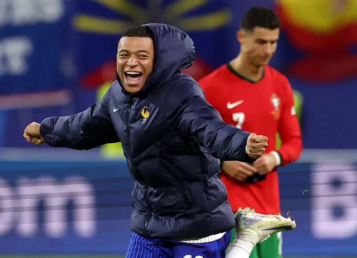 Kylian Mbappé celebrating on the field with Cristiano Ronaldo