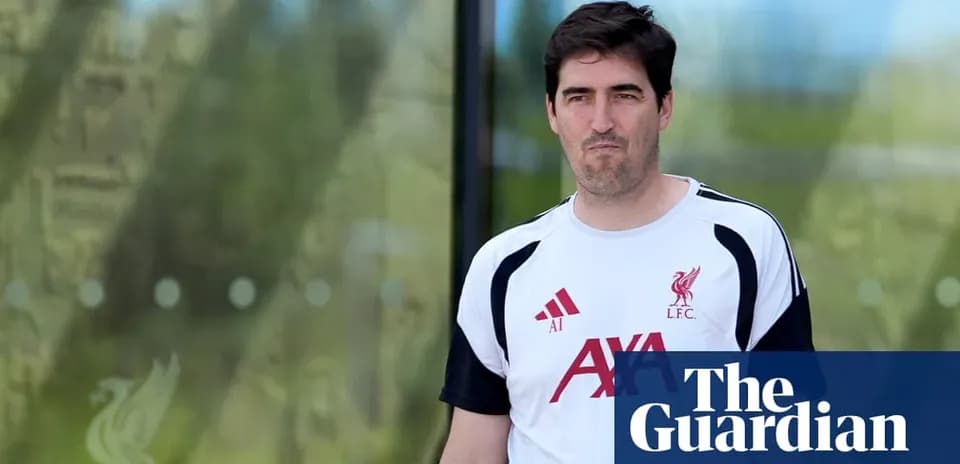 Coach wearing Liverpool kit outside training facility