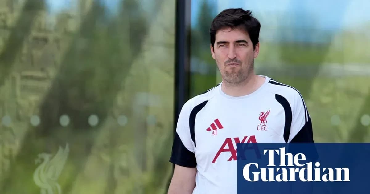 Coach wearing Liverpool kit outside training facility