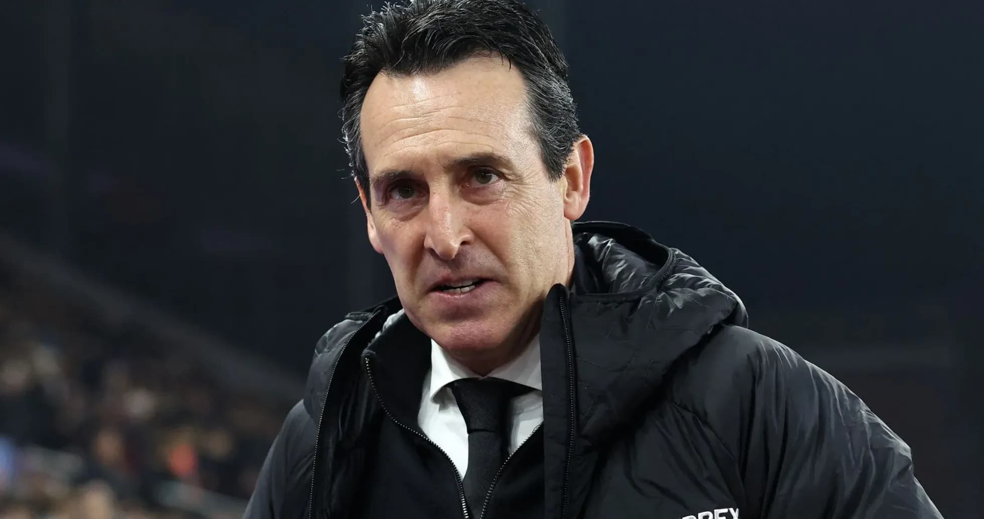 Football manager speaking during a match
