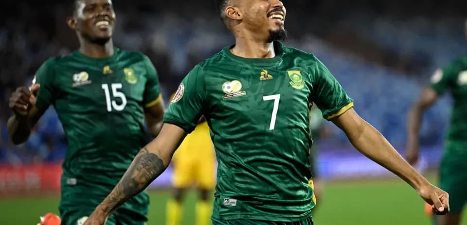 Player celebrating a goal with teammates during match